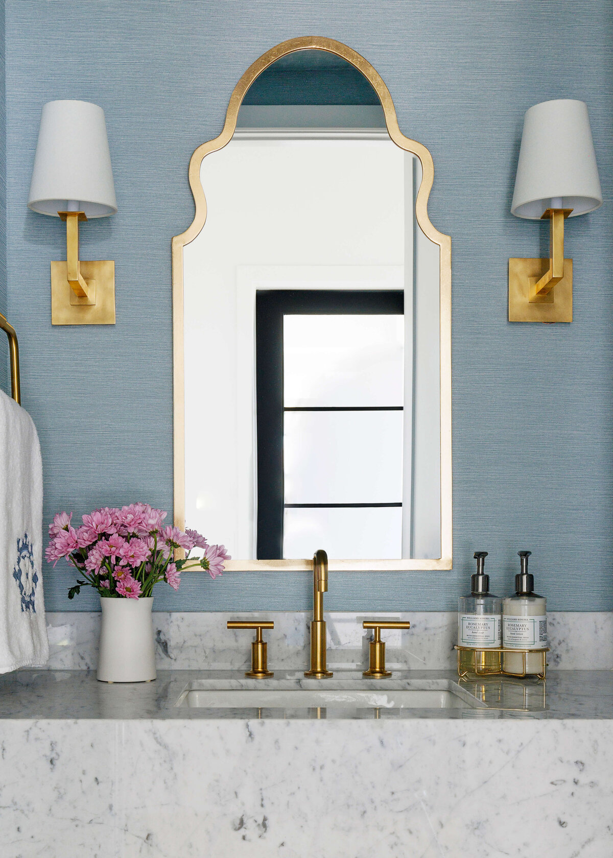 oyster creek studios missouri city new build white marble vanity with gold hardware gold mirror and flowers in bathroom