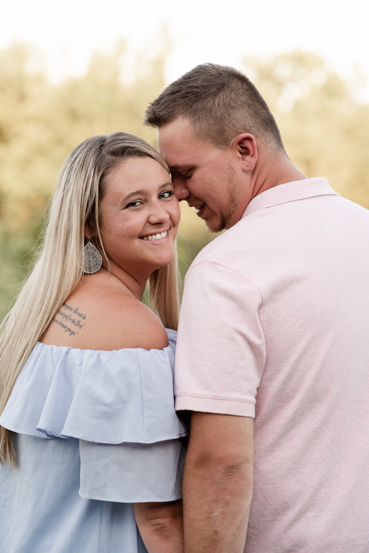 Cute couple with blue dress and pink shirt taken by Michelle Lynn Photography located near Louisville, Kentucky