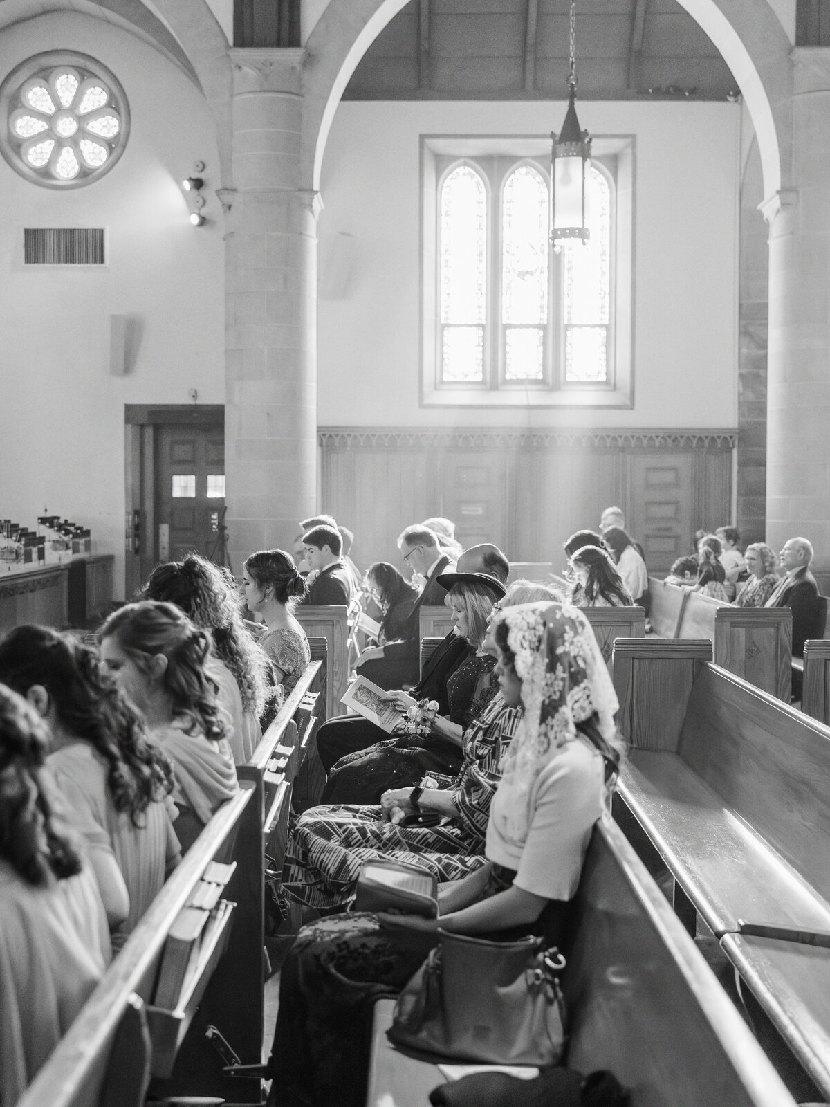 Guests sitting in pews during traditional Latin Mass wedding at St Rita Catholic Church in Alexandria, VA