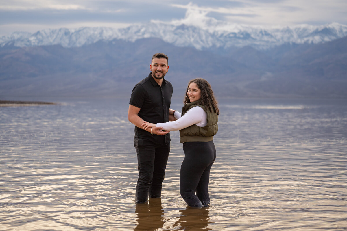 A couple standing in shallow water together