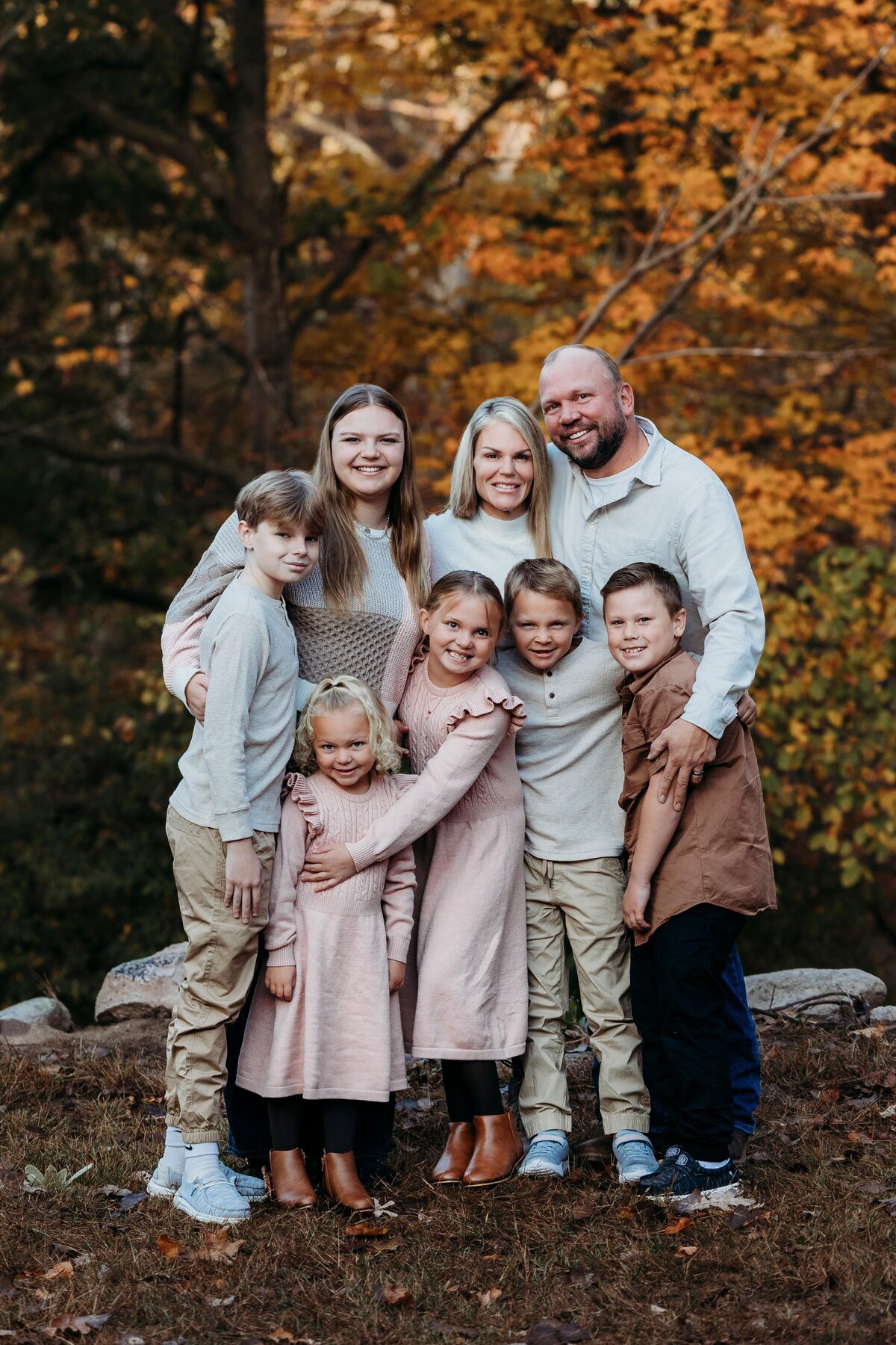 Fall family photoshoot posing together at Bertha Brock Park.