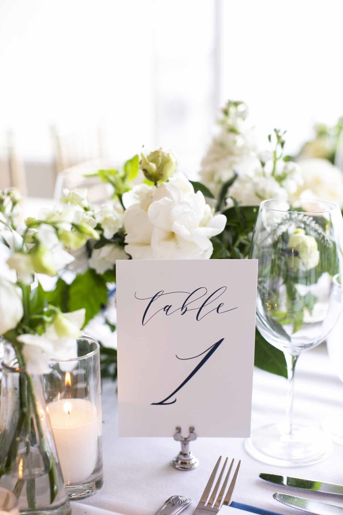 white and green wedding table centerpiece with table number sign