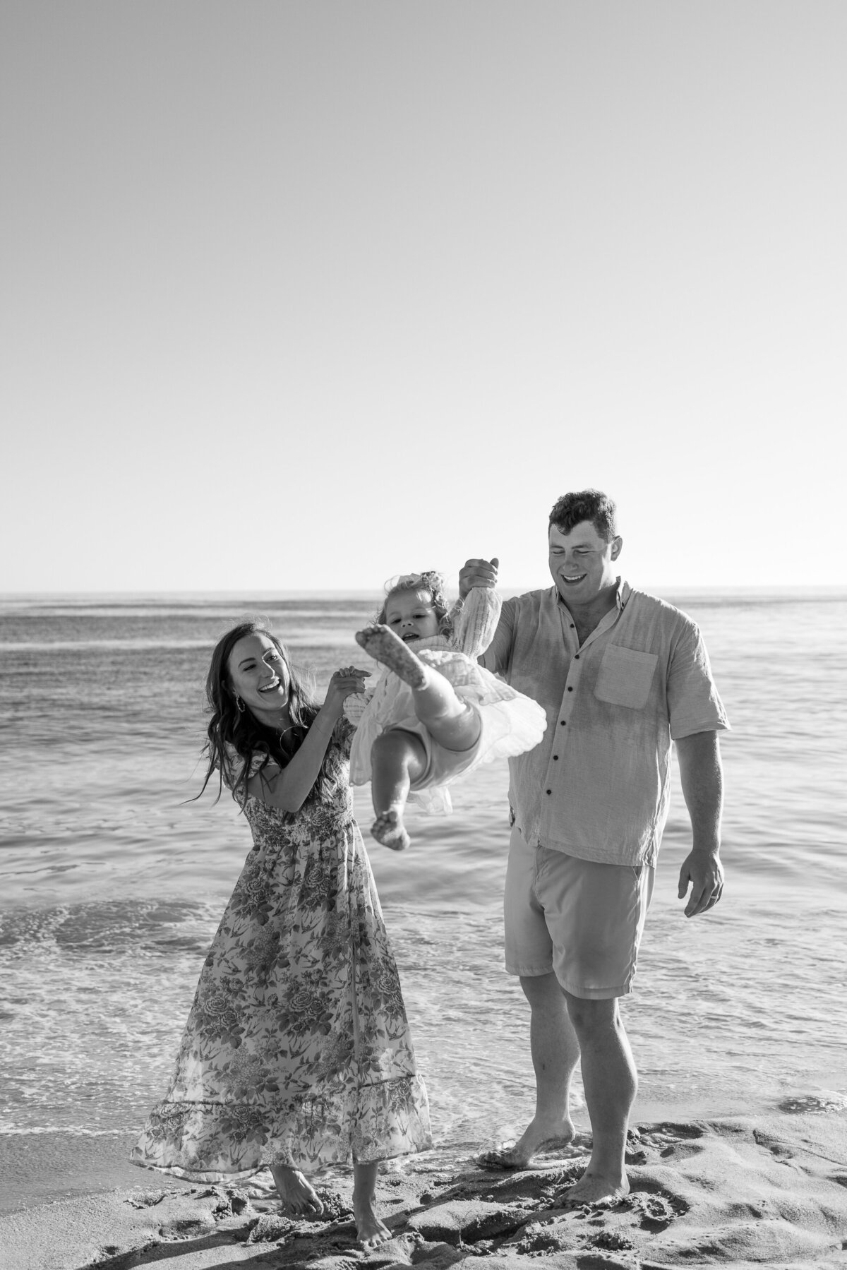 black and white family photo on the beach