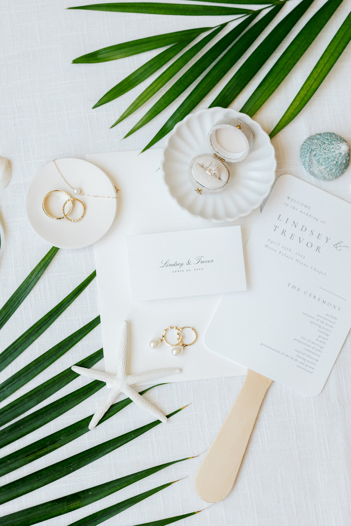 Engagement ring and wedding jewelry flat lay with coastal details, captured in Cancun by a Philadelphia wedding photographer.