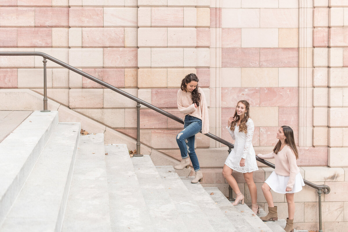 Three Senior girls following one another up steps of Lancaster County Courthouse and looking back at each other.