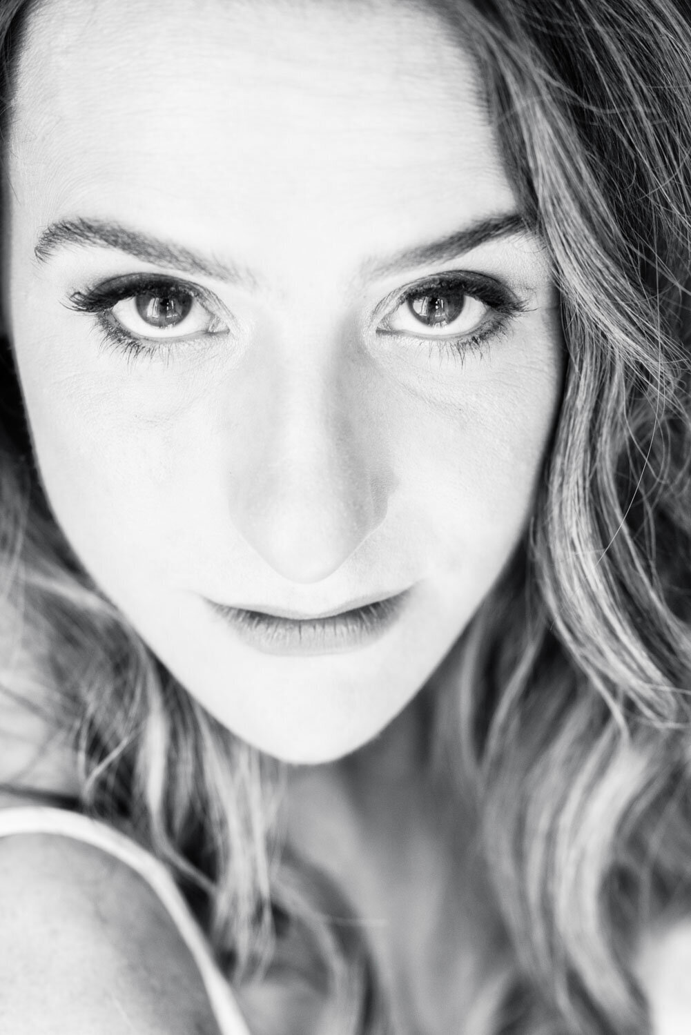 A black and white photo of a woman 's face