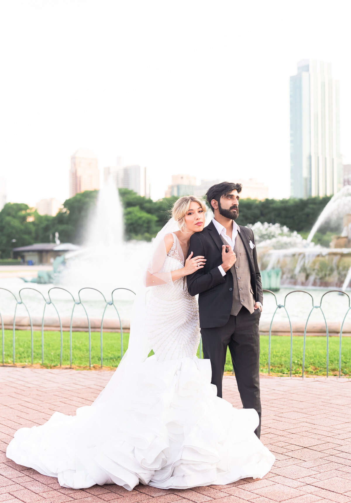 Bride and groom in front of water fountain
