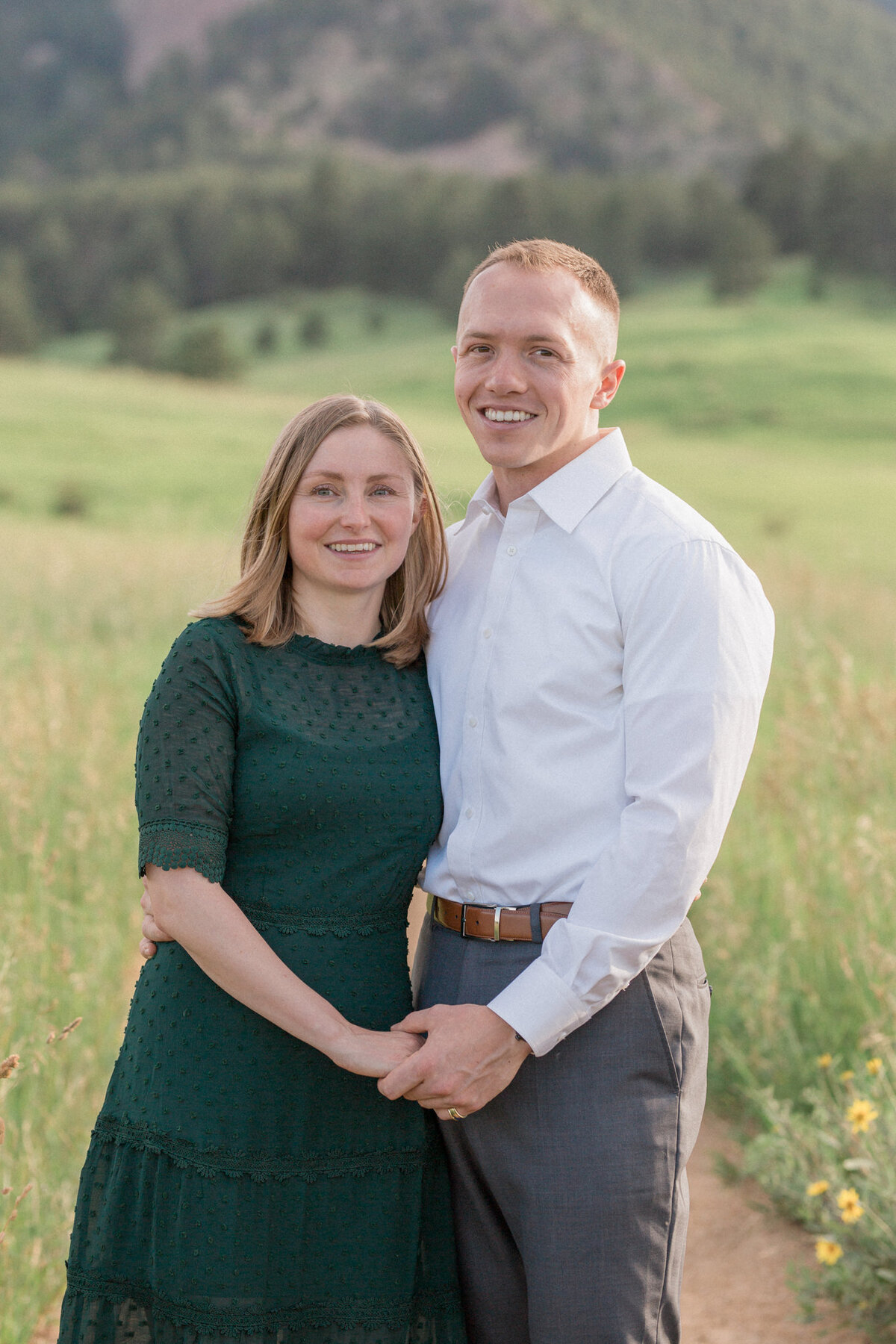 A blond well dressed couple smile during their Boulder engagement photography session with Stephanie Eddy Photography