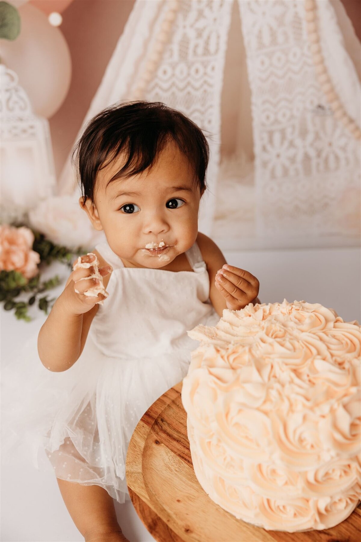 Baby Luna with her cake during her cakemash milestone photoshoot in miochelle kellys papakura photography studio