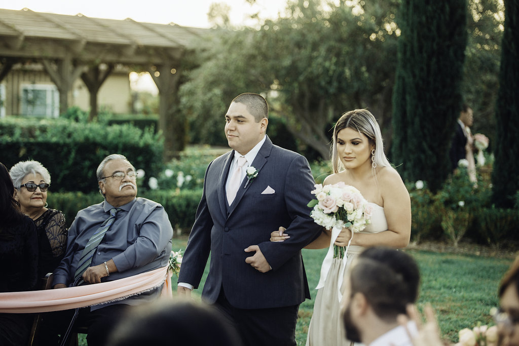 Wedding Photograph Of Groomsman And Bridesmaid Holding A Bouquet Los Angeles