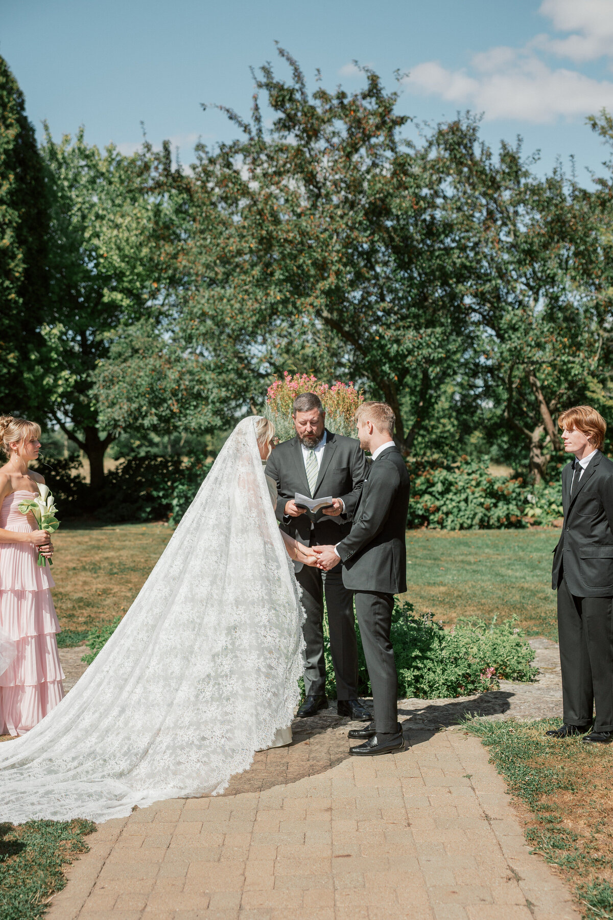 Couple exchanges vows under sunny Dayton skies, photographed by Philadelphia wedding photographer.
