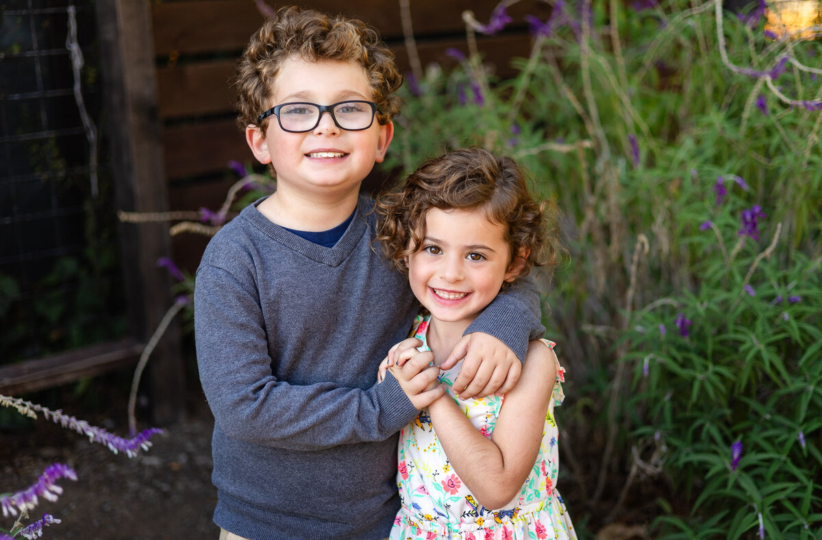 Brother and sister hugging and smiling during Bay Area school photography lifestyle session – Ellobelle Photography