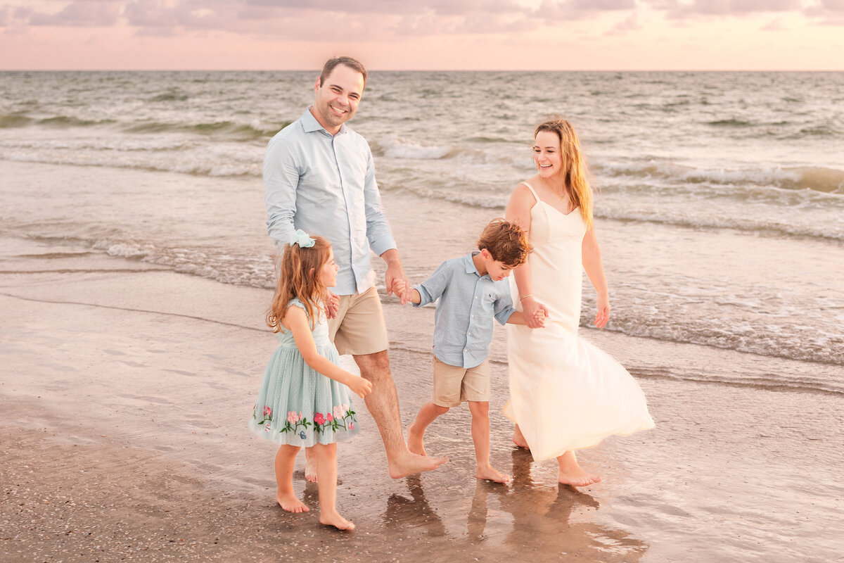 Family enjoying time together on the shoreline at Indian Rocks Beach.