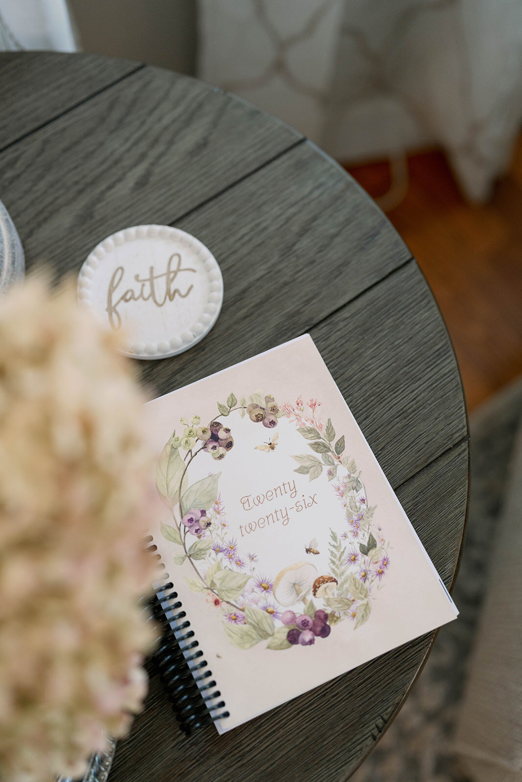 Close-up of a floral cover planner on a round table during a branding session for a planner company in Indiana.