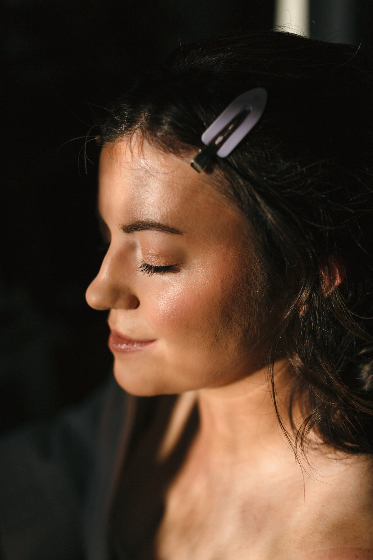 Low winter light hits bride's luminous skin 