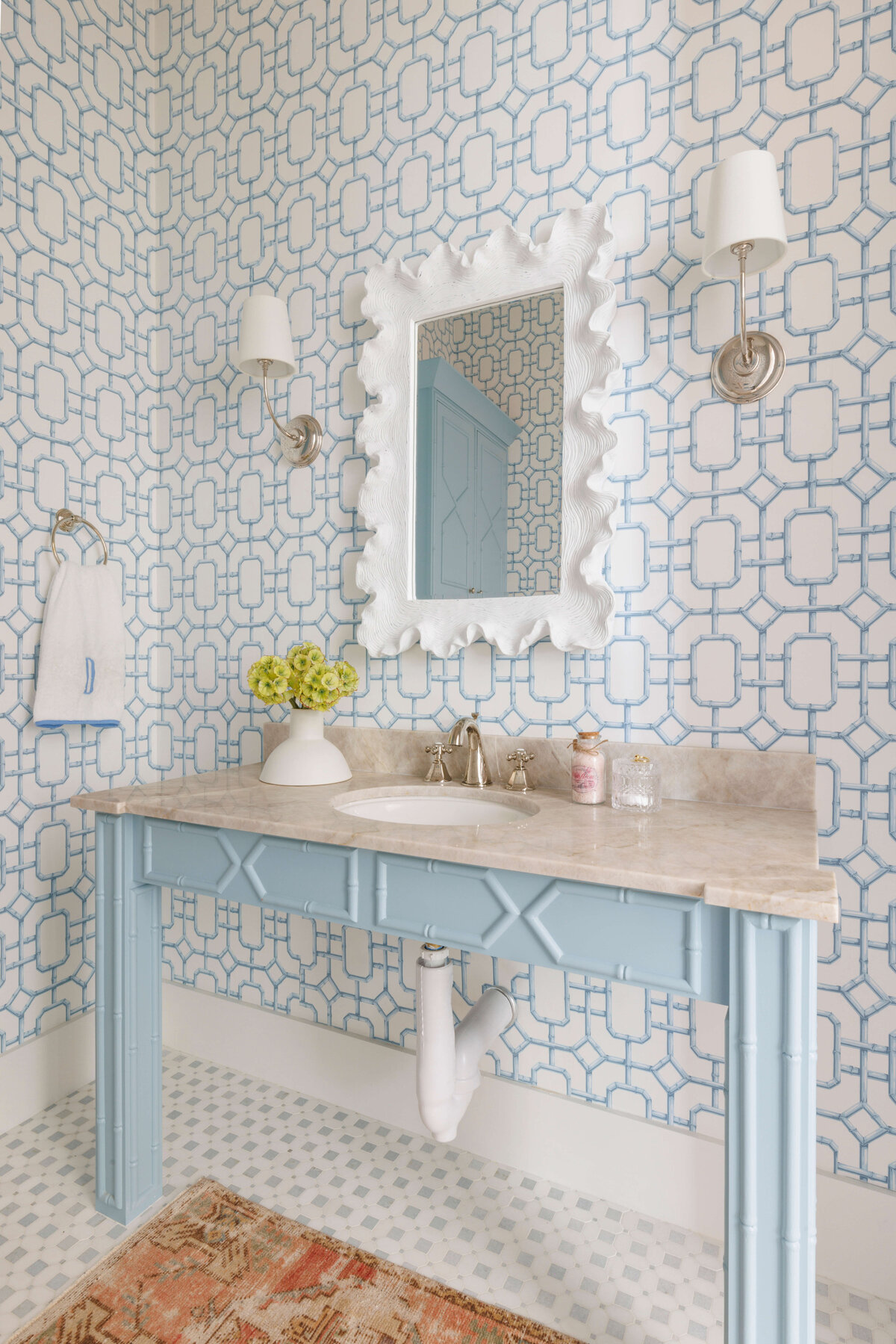 oyster creek studios lighthouse on the lake light blue bathroom vanity with granite countertops and blue pattern wallpaper