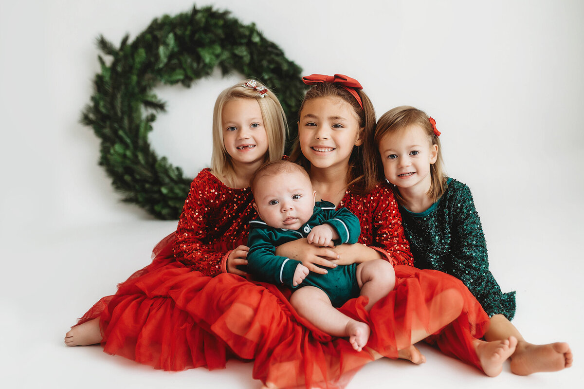 Children pose for Holiday Mini Session in Charleston, SC Photography Studio.