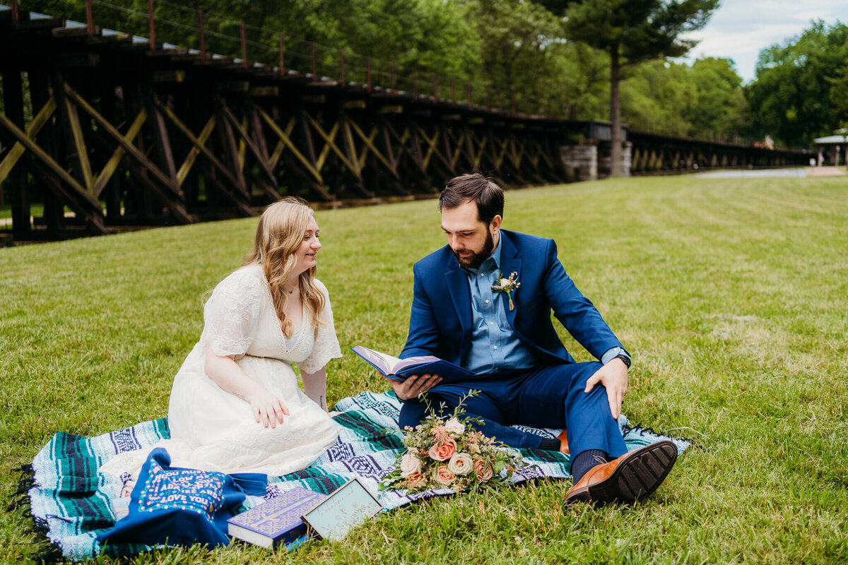 Laid-back picnic-style elopement with couple reading on blanket