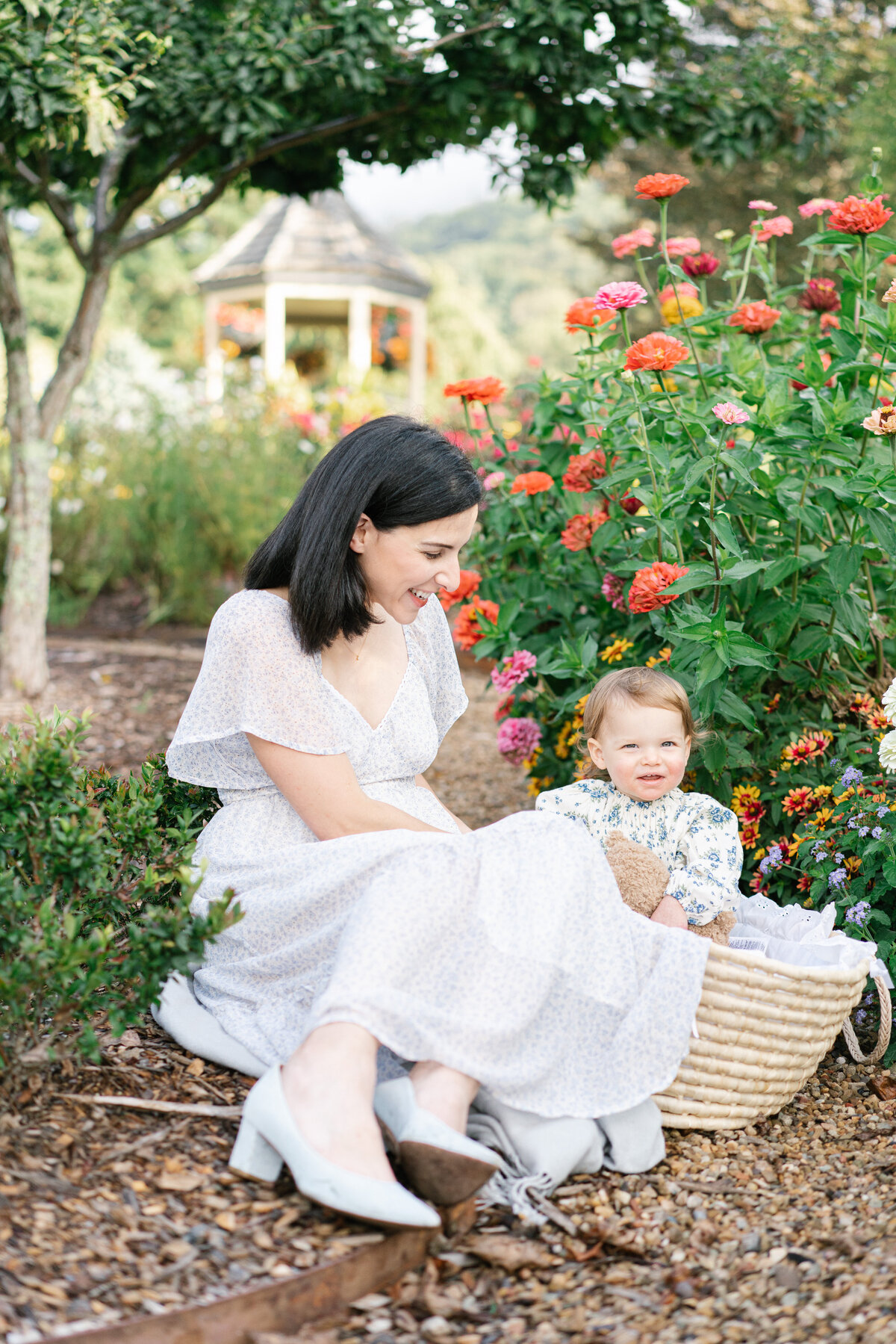 baby in basket with mom  in asheville garden