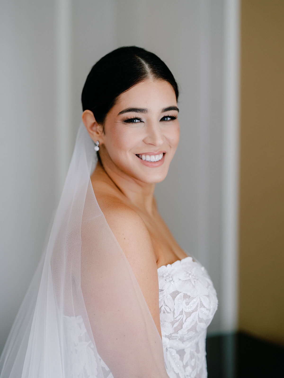 Bridal portrait with happy bride looking at the camera