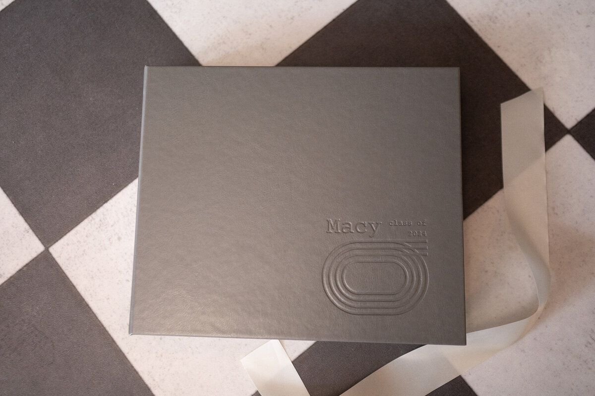 A grey fine art photo album with a white fabric