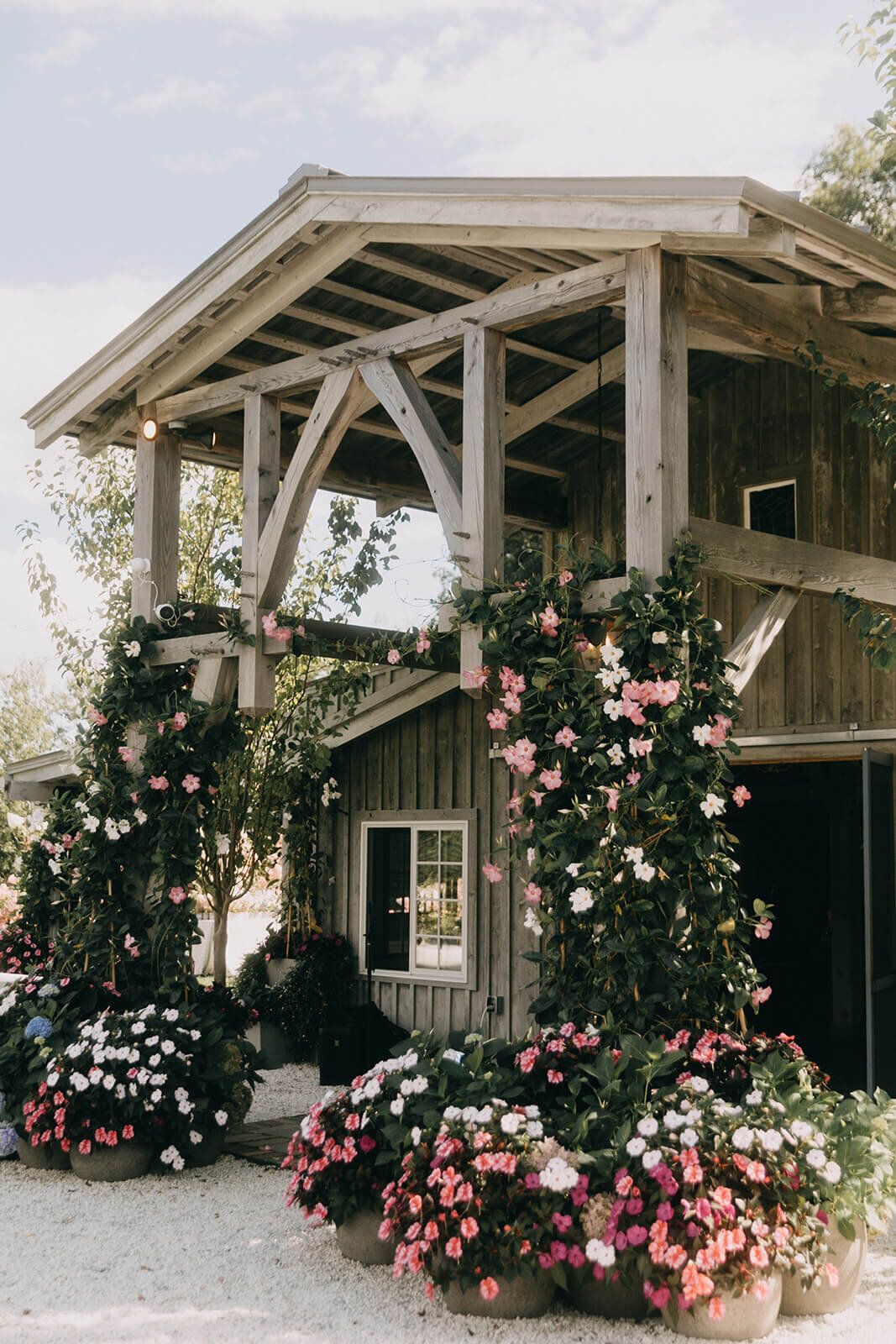 21.rustic-wedding-venue-flower-covered-arch-pink-white-greenery