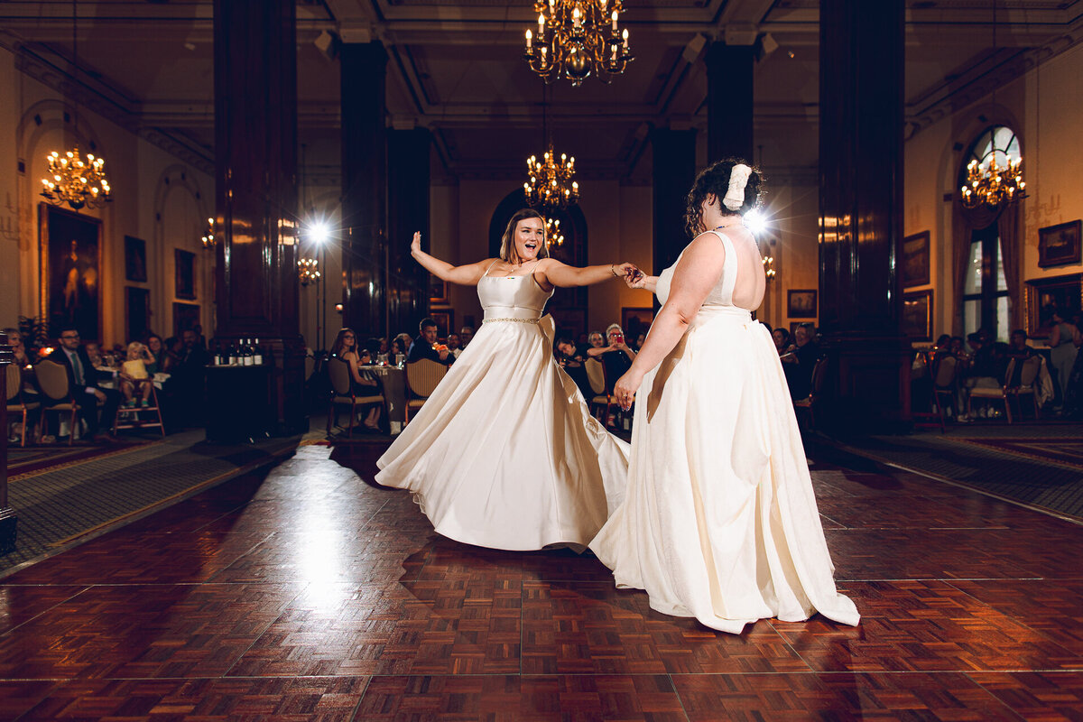 A queer couple share their first dance at their wedding at the Union League Club Chicago 