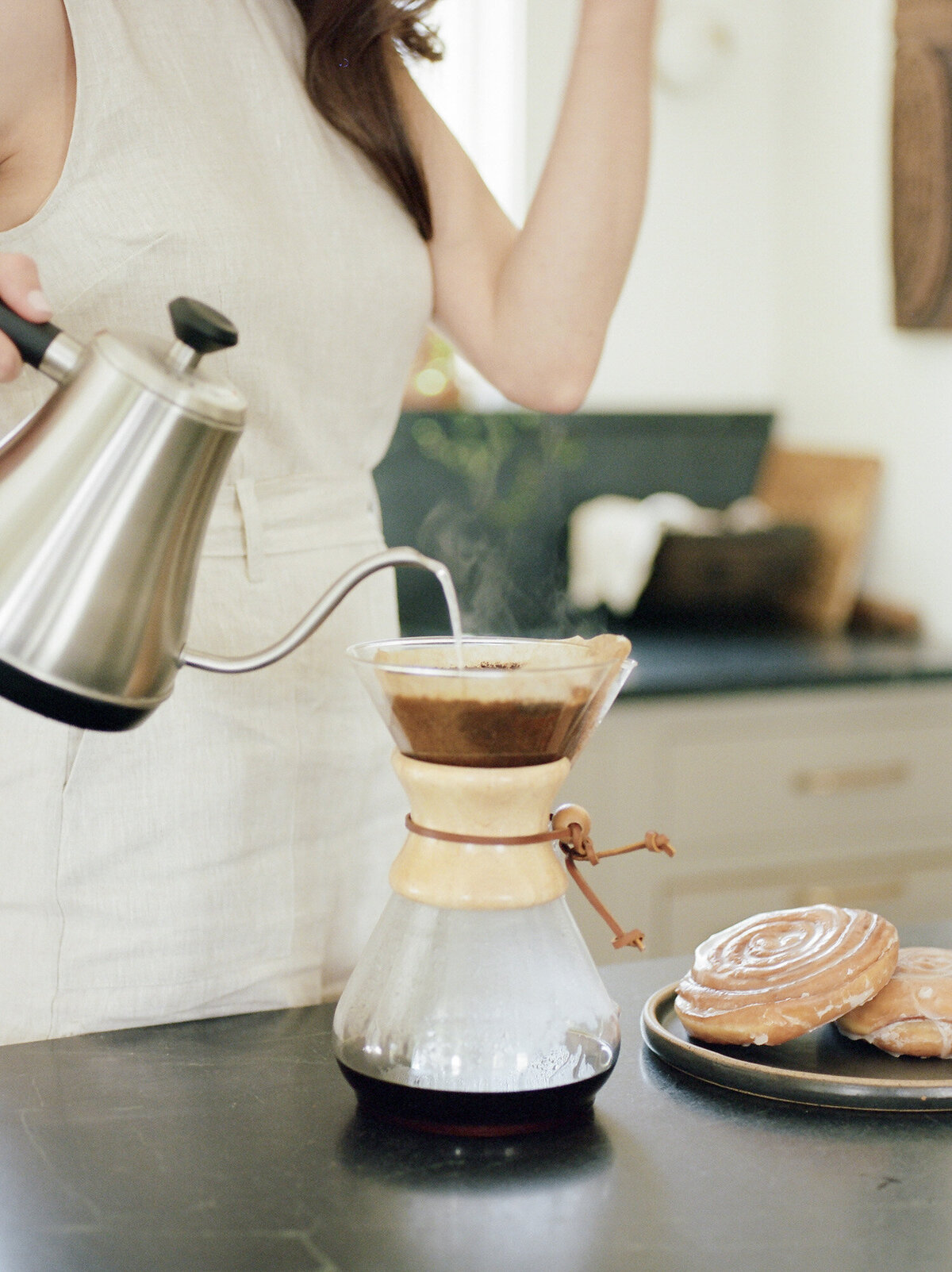 a woman makes pour over coffee, lifestyle film branding photoshoot at Fernhaus, Northern Michigan