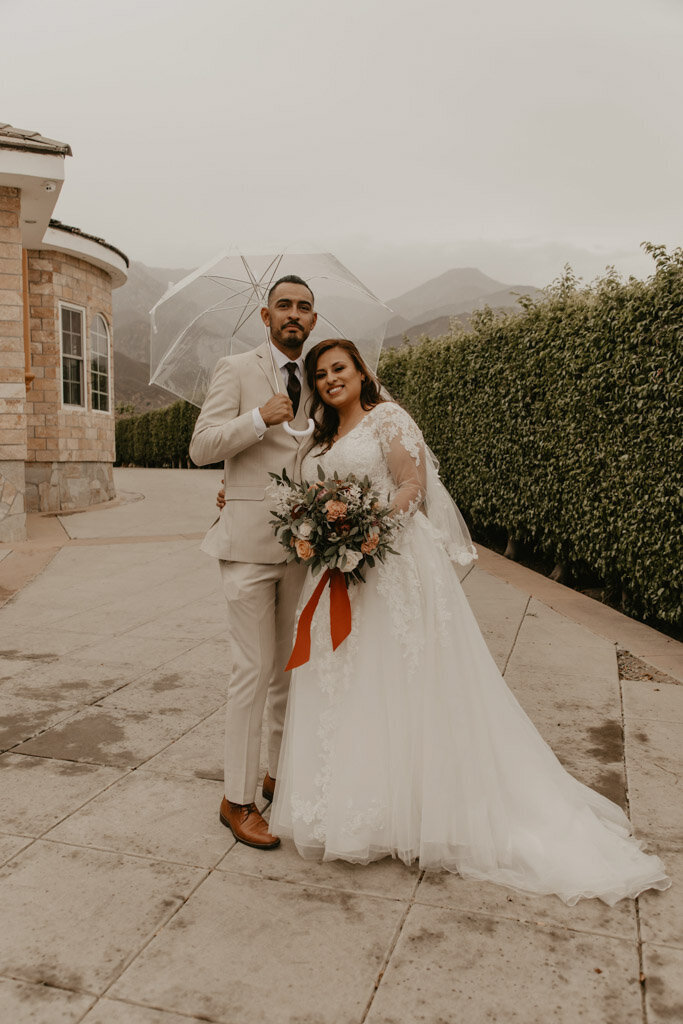 A beautiful couple madly in love on a rainy day
