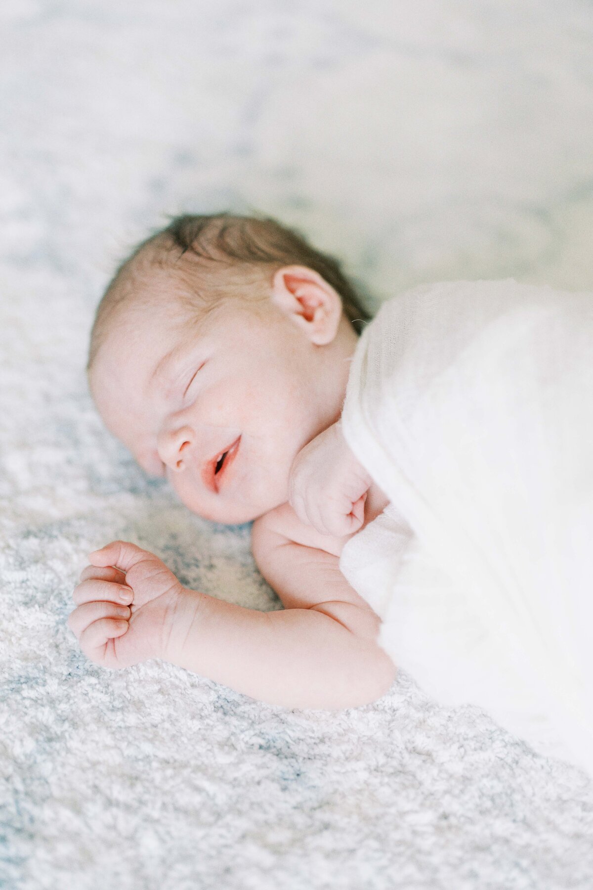 newborn baby smiling