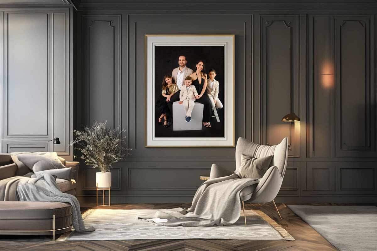 Grey room with a family of five in a photo frame on the wall for their family photography session in Burlington, ON
