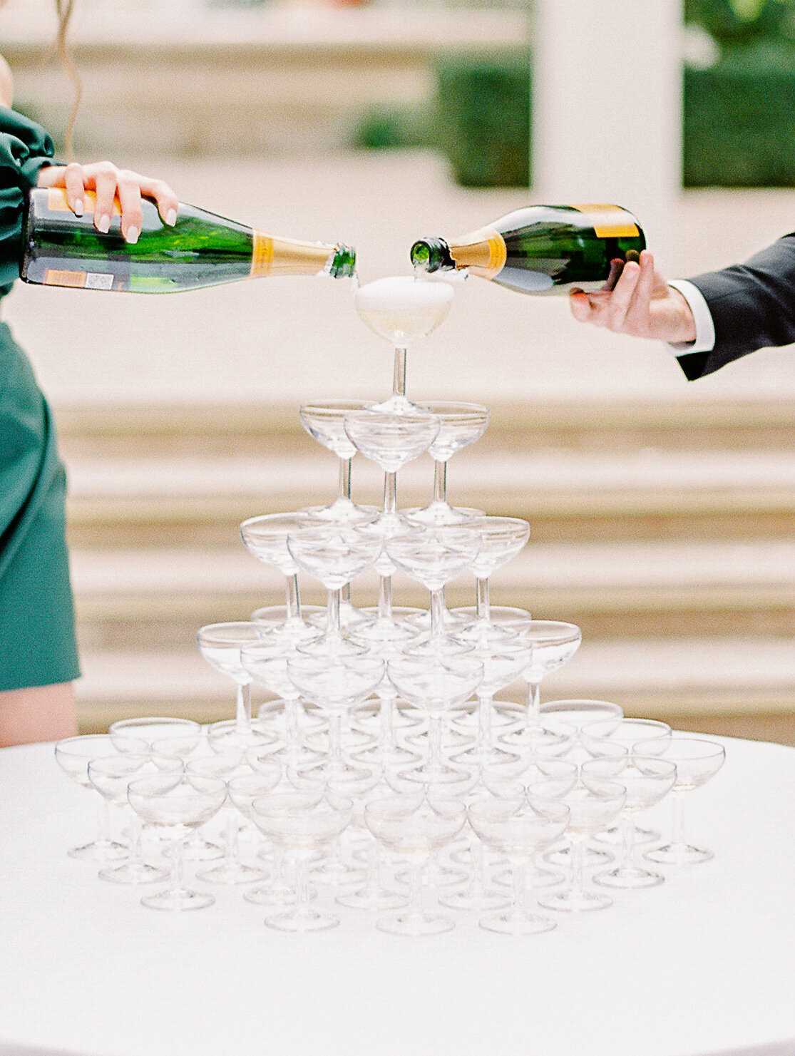 Champagne tower of coupe glasses at a wedding reception at The Ritz Paris photographed by Italy Wedding photographer