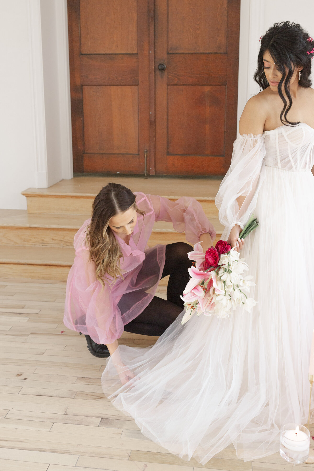 Lancaster wedding planner and floral designer adjusting brides dress