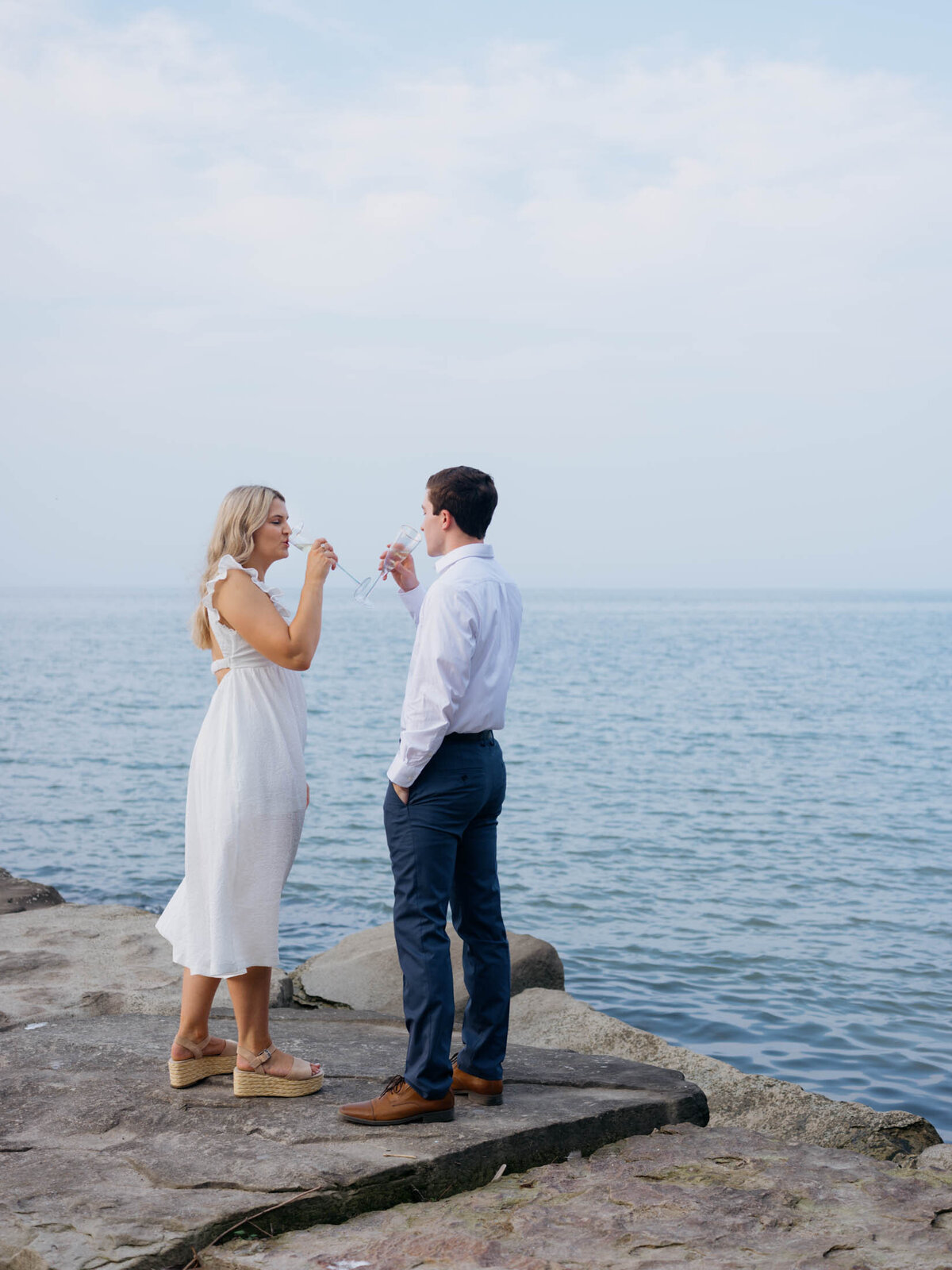 Couple with champagne glasses celebrating their engagement.