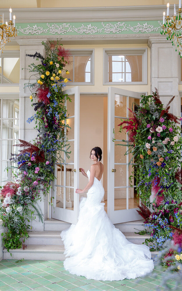 Colorful and classic arrangement of florals surrounding a beautiful St Augustine bride during a wedding