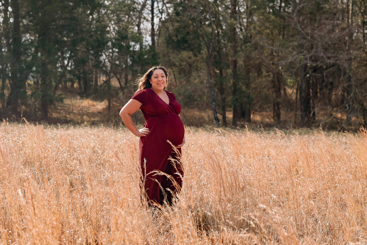 pregnant woman standing in a field