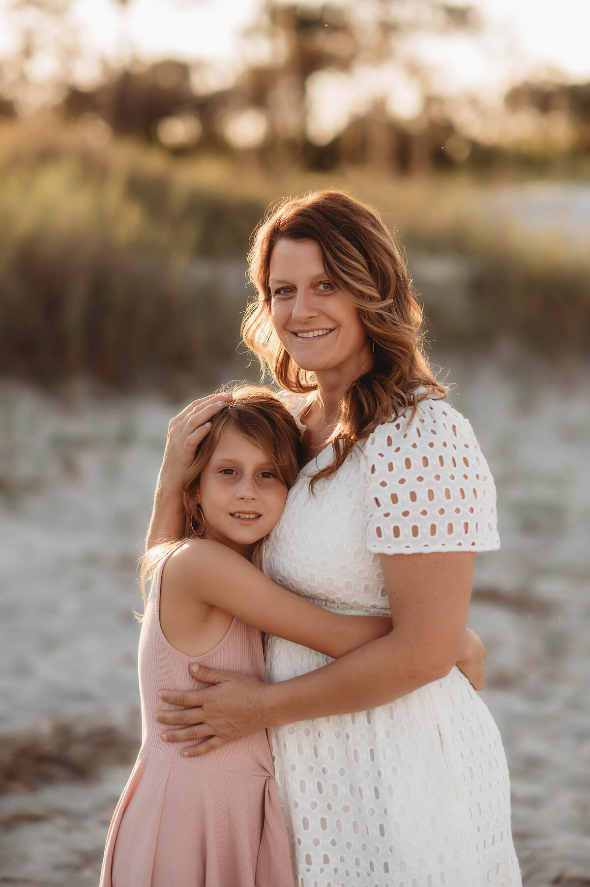 Mother embraces her daughter during Family Photos on Folly Beach.