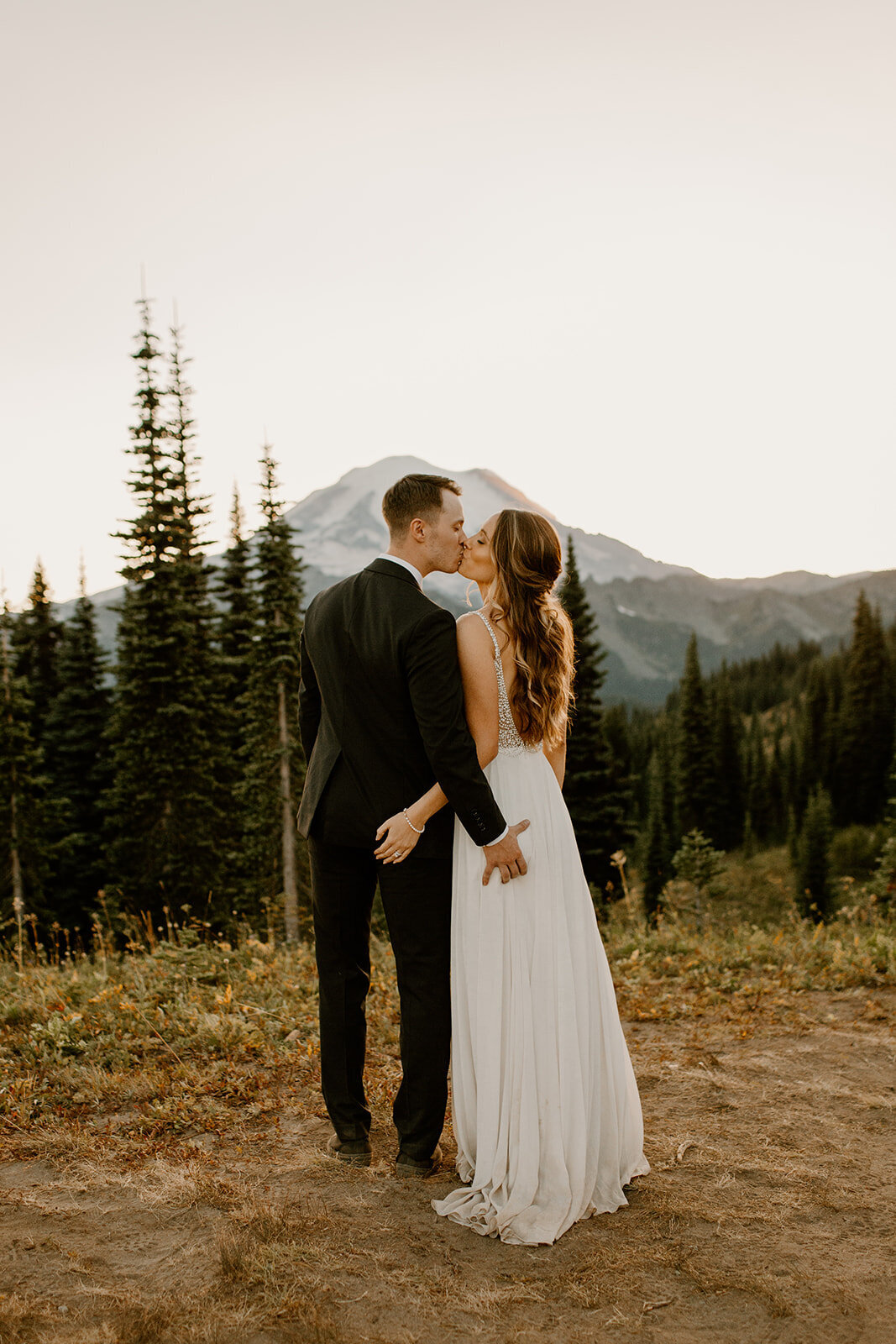 Bride & groom kissing and grabbing each other's butts in front of Mount Rainier!
