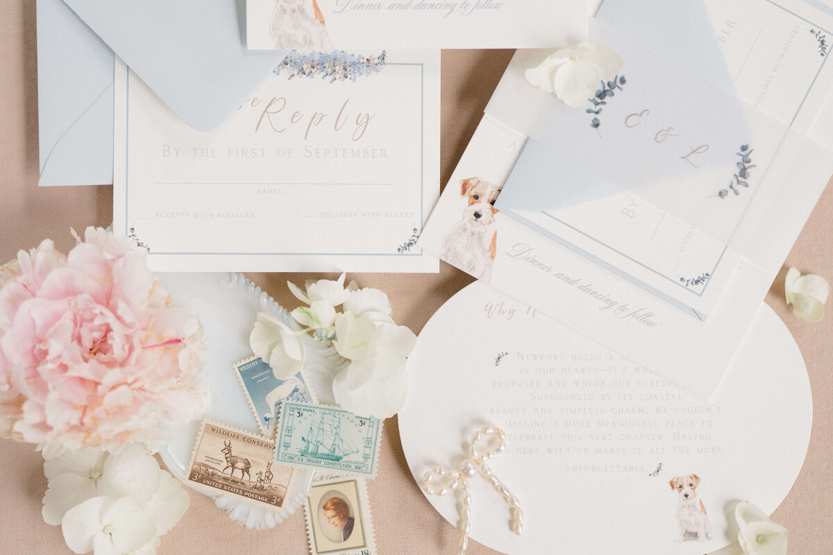 Custom coastal wedding invitation suite with delicate florals, classic typography, and a watercolor dog illustration by White Heart Design.