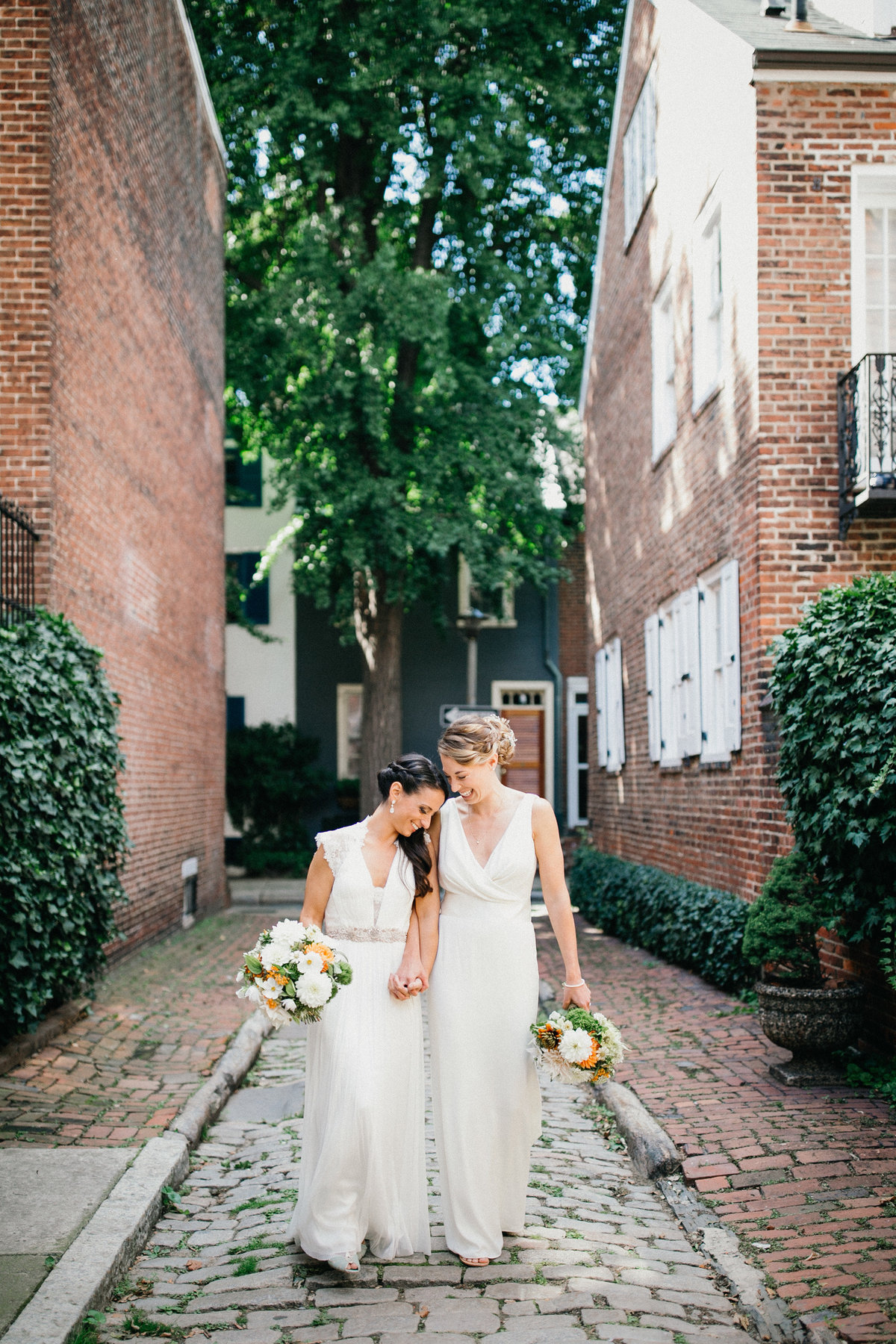Two brides photographed in Old City, Philadelphia before their ceremony.