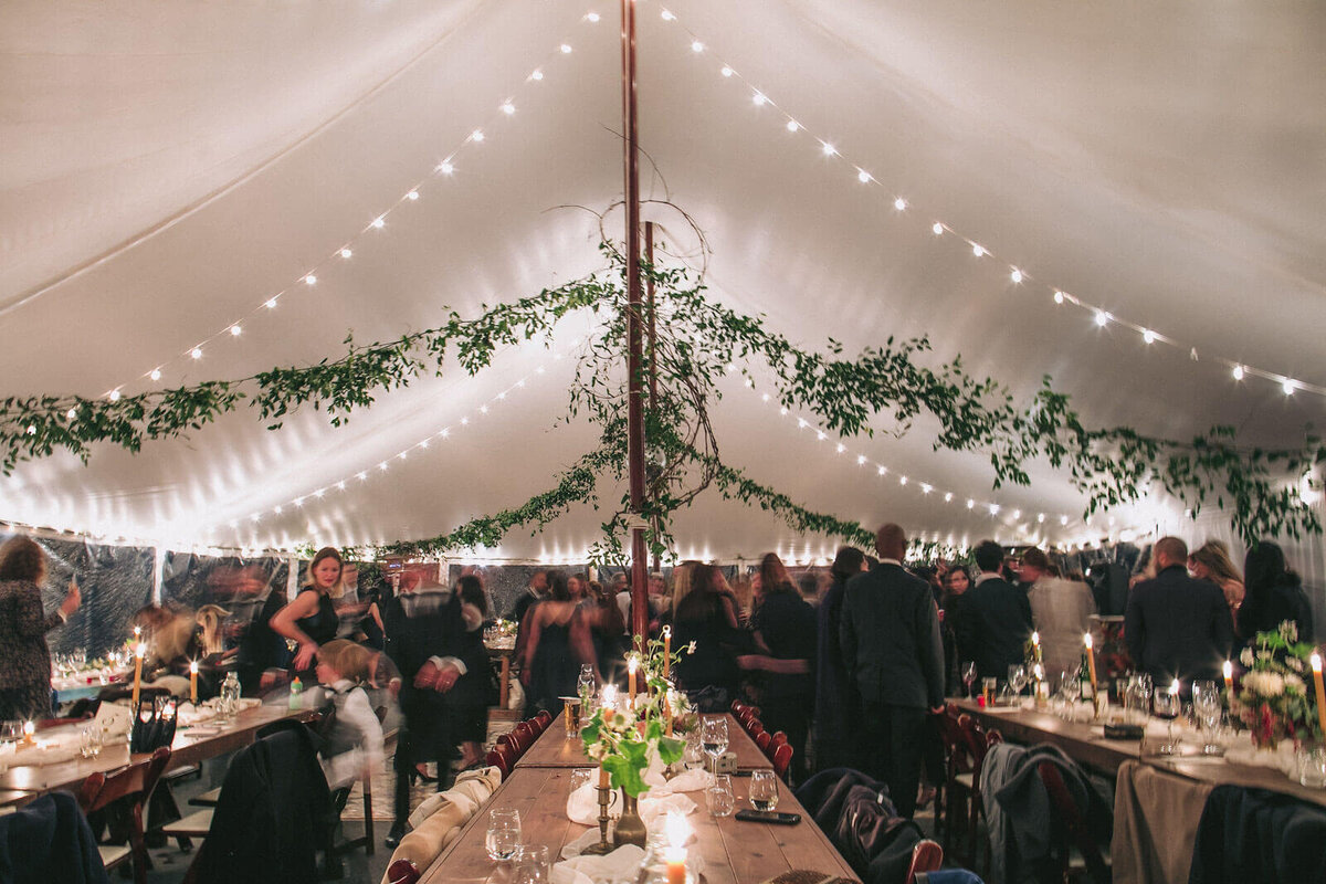 The guests are all dancing on the dance floor in Foxfire Mountain House, New York. Wedding Image by Jenny Fu Studio
