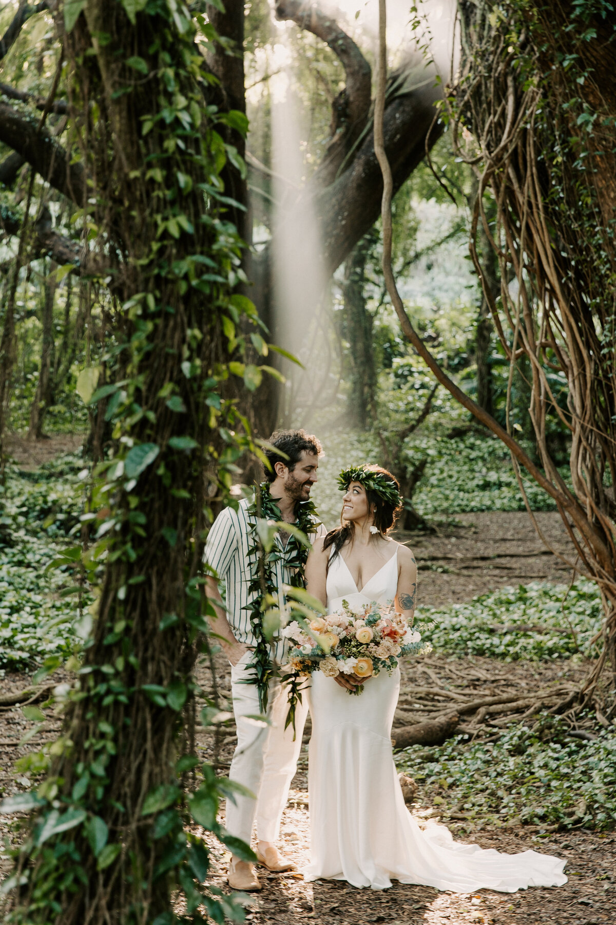 Maui Wedding Photographer captures bride and groom standing in forest