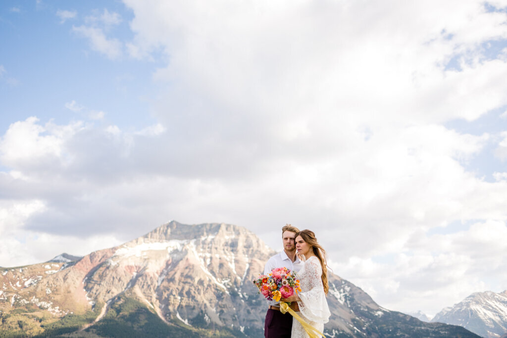 Bride and groom in mountains, captured by Andrea De Groot Images, vibrant and joyful wedding photographer in Lethbridge, Alberta. Featured on the Bronte Bride Vendor Guide.