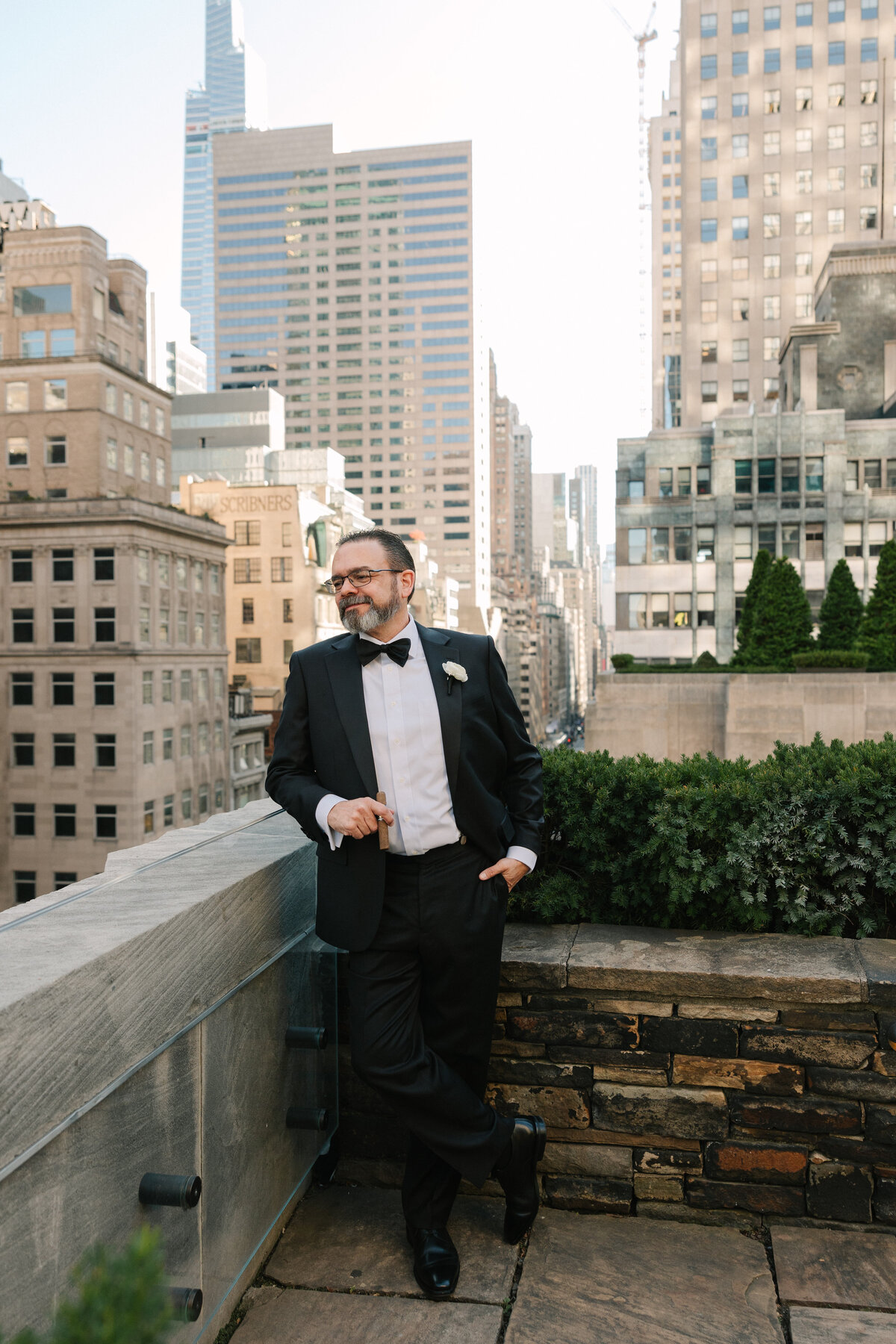 Groom overlooking the ledge down to new york city
