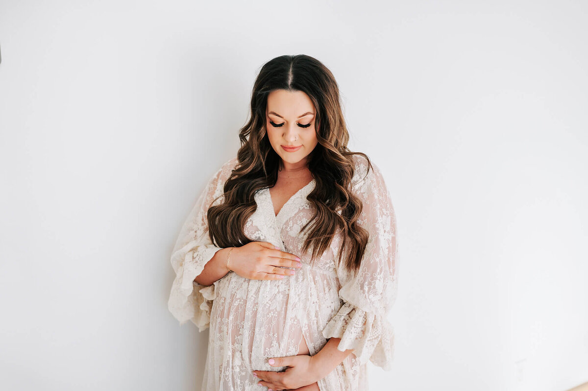 Springfield MO maternity photographer captures pregnant mom looking at baby bump