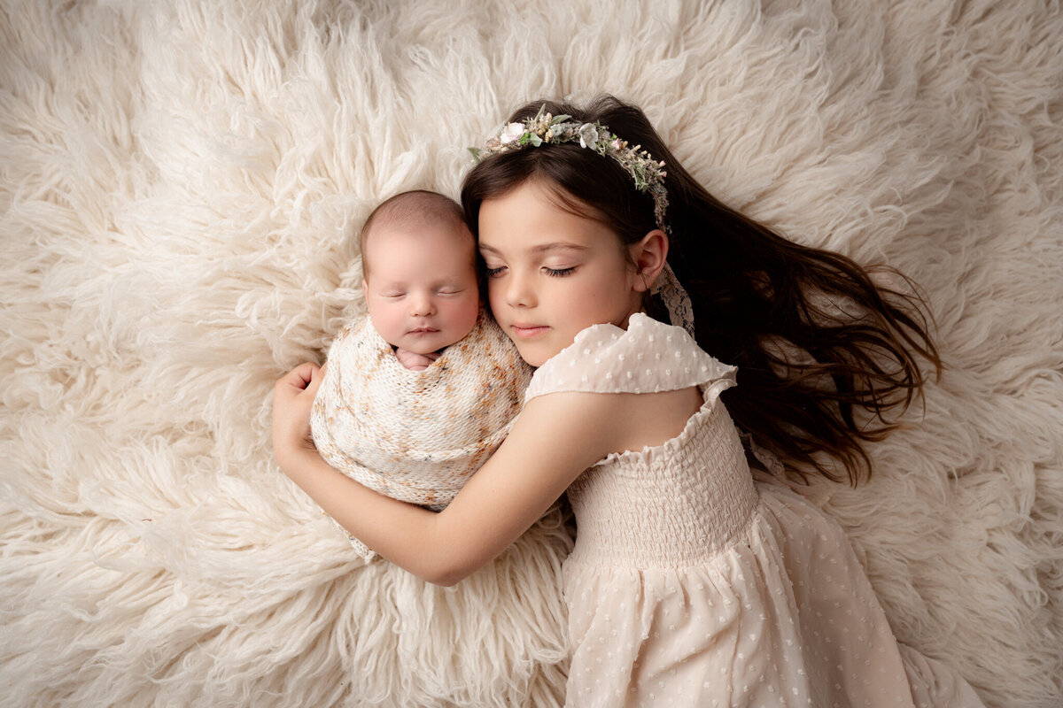 Brighton Newborn Photography Baby Held by sister By For The Love Of Photography