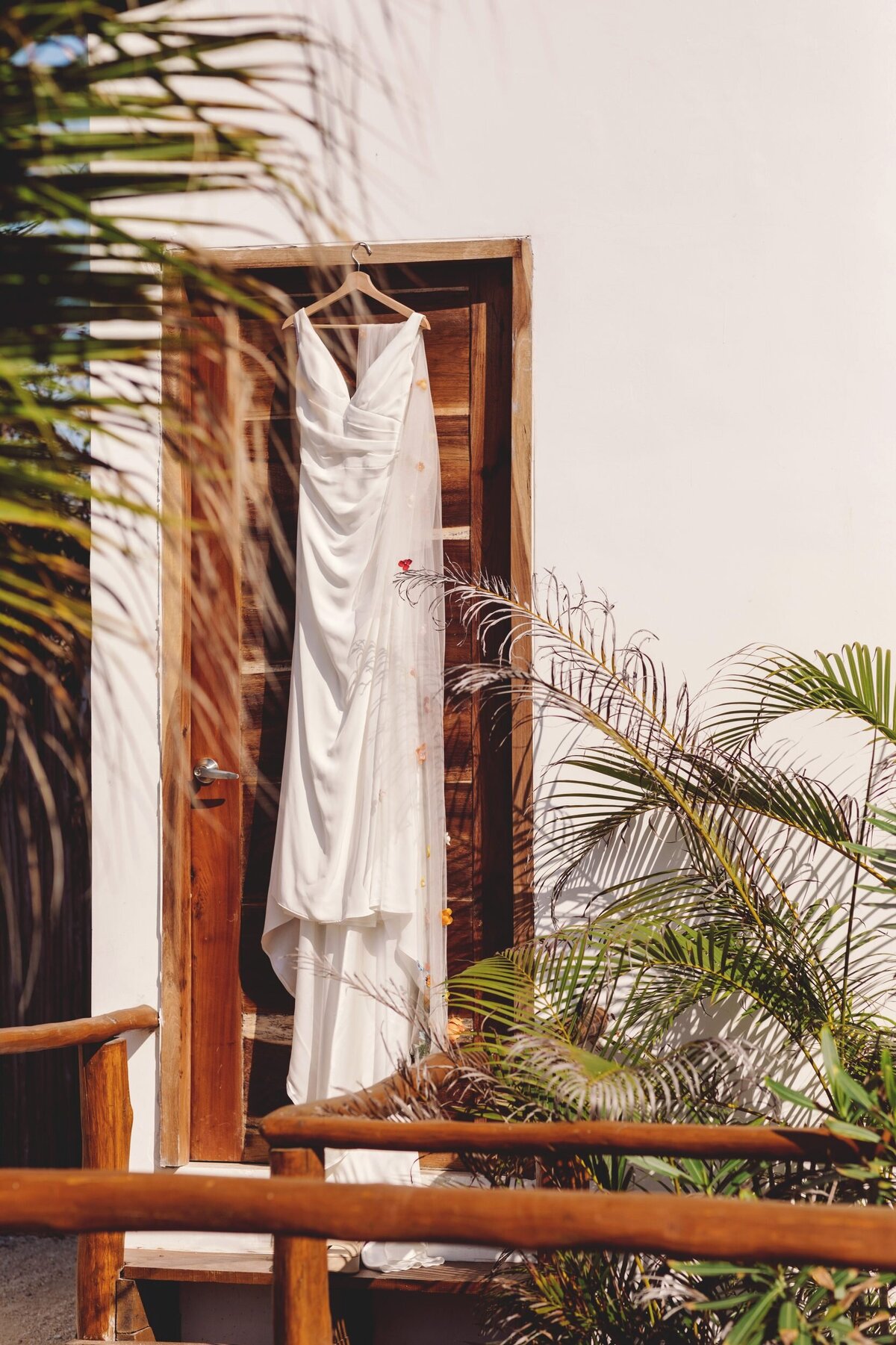 Dress hanging outside on door at Blue Venado Seaside Riviera Maya wedding