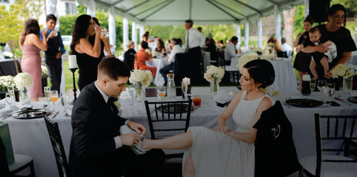 groom-tying-brides-shoelaces