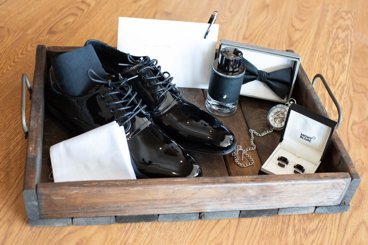 groom's details include shoes, tie cologne cuff links and letter in tray at Sendera Springs in Kerrville Texas