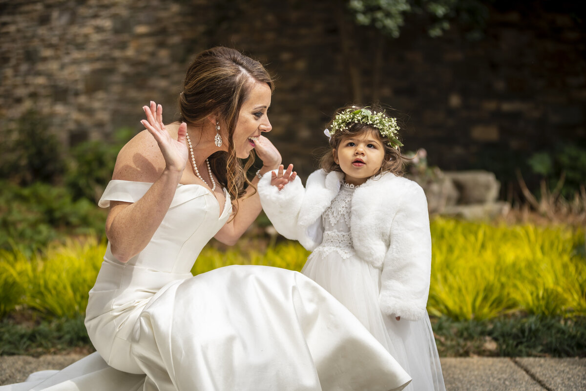 Bride playing with flower girl.